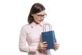 Adult happy woman in glasses pink shirt looking in shopping bag. White background isolated Royalty Free Stock Photo