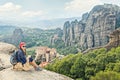 Adult happy woman traveler enjoys landscape with volcanic mount