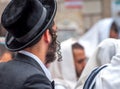 An adult Hasid in a traditional hat and with long payos. Prayer of Hasidim