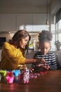 Adult helping child with craft project