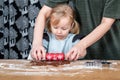 Adult Helping Child Roll Gingerbread Dough with Holiday Baking Tools Royalty Free Stock Photo