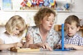 Adult Helping Two Young Children at Montessori/Pre Royalty Free Stock Photo