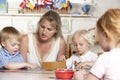 Adult Helping Young Children at Montessori/Pre-Sch Royalty Free Stock Photo