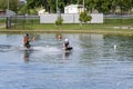 Adult Helps Child To Kneeboard