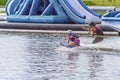 Adult Helps Child To Kneeboard
