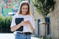 Adult high school student girl using app on modern smartphone Royalty Free Stock Photo