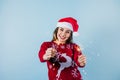 Adult hispanic woman holding christmas sparkling lights for mexican posada in christmas on yelllow background in Mexico Latin Amer