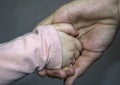 An adult holds a child& x27;s hand close-up. Royalty Free Stock Photo