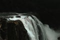 an image of a person standing at the edge of a waterfall