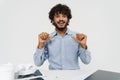 Adult indian man is pointing on himself by the table Royalty Free Stock Photo