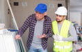 Adult interior designer giving instructions to construction team foreman Royalty Free Stock Photo