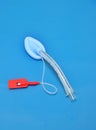 An adult laryngeal mask airway (LMA). Image isolated on blue background. Royalty Free Stock Photo