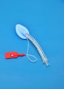 An adult laryngeal mask airway (LMA). Image isolated on blue background.