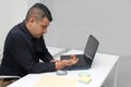 Man suffering from pain in his wrist due to Carpal Tunnel Syndrome while working in his office with his laptop and mouse