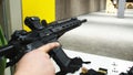 Adult loading an assault rifle at a shooting range. Royalty Free Stock Photo