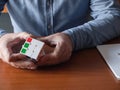 Adult male Caucasian hands hold Rubik\'s cube