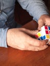 Adult male Caucasian hands hold Rubik\'s cube