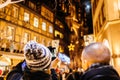 Male couple taking photo of Notre-Dame and Christmas Market deco