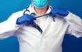 Adult male doctor in a white coat tears off his tie Royalty Free Stock Photo