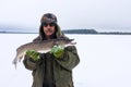 Adult male fisherman holds a large pike fish. winter fishing Royalty Free Stock Photo