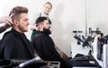 Adult male having their hair cut by hairdressers