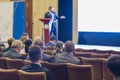 Adult Male Host Speakers Standing in Front of the Audience During the Conference. Royalty Free Stock Photo