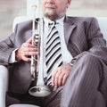 Adult male musician sitting in a chair Royalty Free Stock Photo