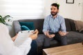 Adult male patient talking with a young female psychologist Royalty Free Stock Photo