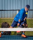 Adult male pickleball player with eyes on the ball