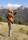 Elk hunter calling for elk in rugged mountains