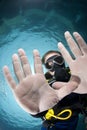 Adult male scuba diver showing his hands.