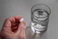 Adult male senior taking medication with water