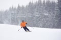 Adult male skiing during heavy snowfall. Monochrome view. Recreational outdoors sports vacation, leisure on solitude