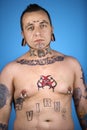 Adult male with tattoos and piercings.