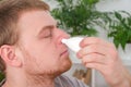 An adult male uses a nasal spray to relieve a runny nose. concept of medicine, health. Royalty Free Stock Photo