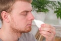 An adult male uses a nasal spray to relieve a runny nose. concept of medicine, health. Royalty Free Stock Photo