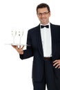 Adult male waiter serving two glass of champagne isolated Royalty Free Stock Photo