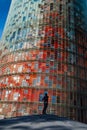 An adult man admiring the Torre GlÃÂ²ries GlÃÂ²ries Tower in Sant MartÃÂ¬ district, Barcelona, Spain Royalty Free Stock Photo