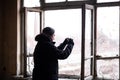 Man taking photos with his mobile inside of an abondened building room on a cold winter day Royalty Free Stock Photo