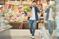 Adult Man Calling by Smartphone in Supermarket Royalty Free Stock Photo