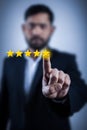 Adult man choosing five star rating for customer feedback