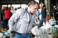 Adult man is choosing old things at the fleamarket Royalty Free Stock Photo