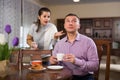 Man ignoring disgruntled wife reprimanding him