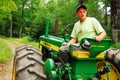 An adult man drives his tractor on a tour of his farm Royalty Free Stock Photo