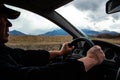 Adult man driving a car, backlight Royalty Free Stock Photo