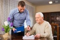 Adult man with elderly father analyzing papers Royalty Free Stock Photo