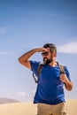 Adult man enjoy outdoor wild nature and adventure leisure activity alone walking inthe desert - mountains and blue sky in Royalty Free Stock Photo
