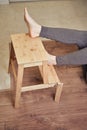 Adult man falls off a ladder due to a broken chair leg. Safety issues at work at height due to disruption to work at home Royalty Free Stock Photo