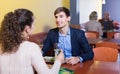 Adult man and girlfriend chatting as having date