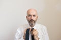 One mid age man with beard is knotting his necktie Royalty Free Stock Photo